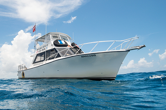 Narcosis is a spacious Pro 48 Custom Dive Boat used for SCUBA charter trips in West Palm Beach